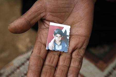 Hammad’s aunt or mother holds the last remaining photo of him in the palm of her hand.