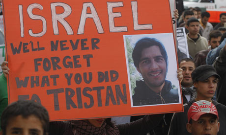 Protestors hold up a poster of Tristan Anderson, who was injured by Israel troops. Photograph: Nasser Shiyoukhi/AP