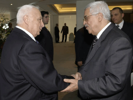 Abbas and Sharon shake hands.
