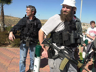 Photo of two heavily armed Israeli settlers in the West Bank settlement of Efrat.