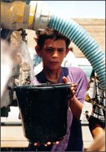 A child gets water from a watertank