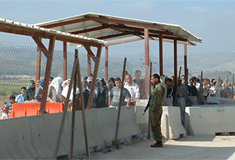 Photo of Palestinians waiting at checkpoint.