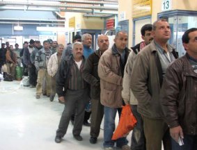 Palestinians wait to show their IDs and be searched at Einab terminal on their way home from work.