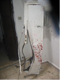 Blood on destroyed door.