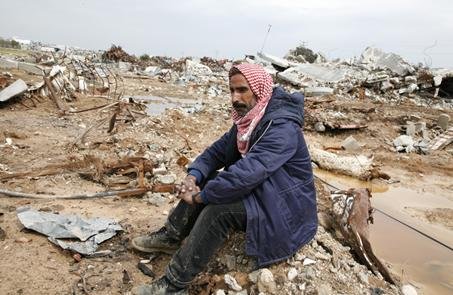 Hammad’s father Barrak Salem Salaam Silmiya, surrounded by the carcasses of his livestock and the remains of his home.